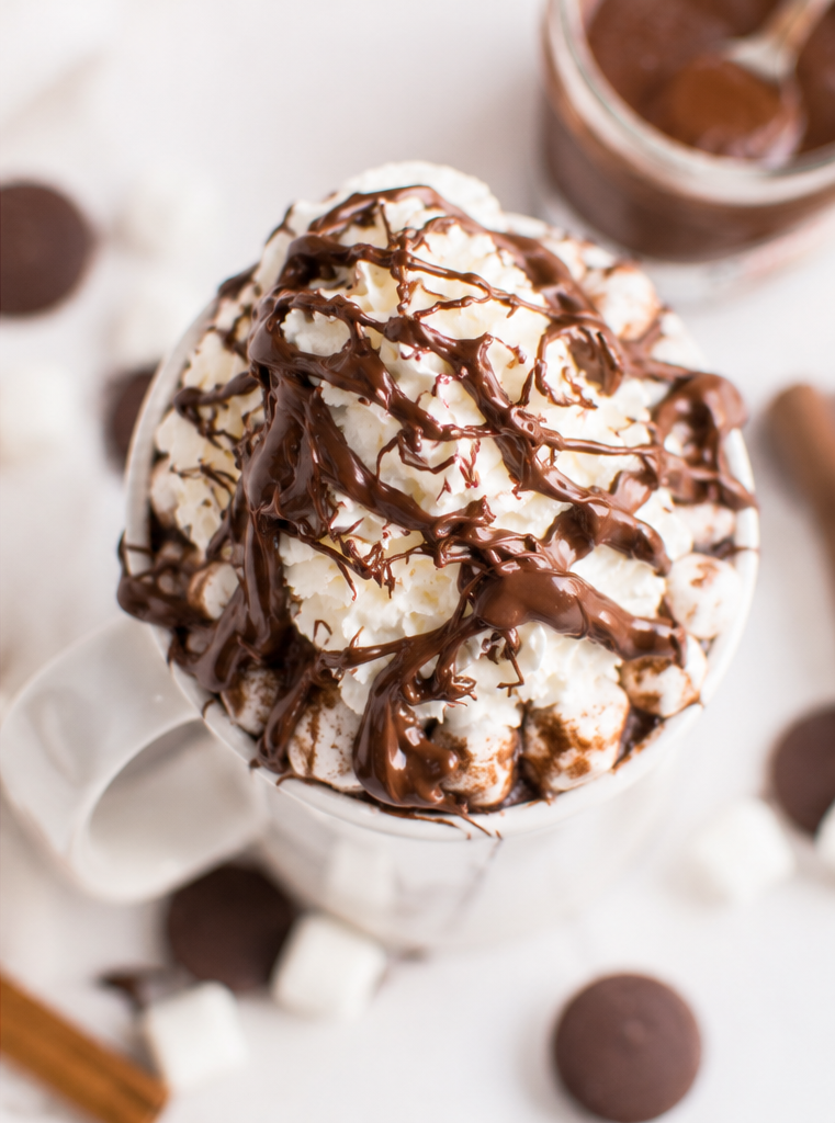 Creamy Nutella eggnog hot chocolate topped with whipped cream, marshmallows, and extra Nutella