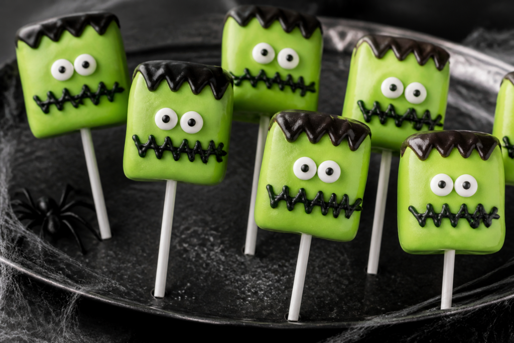 Easy no-bake Frankenstein marshmallow pops with stitched zig-zag drizzle and monster faces