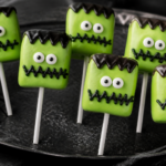 Easy no-bake Frankenstein marshmallow pops with stitched zig-zag drizzle and monster faces