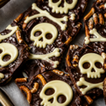 Halloween chocolate skull & bones pretzel bark: dark chocolate sheet with crushed pretzels and white chocolate skull outlines