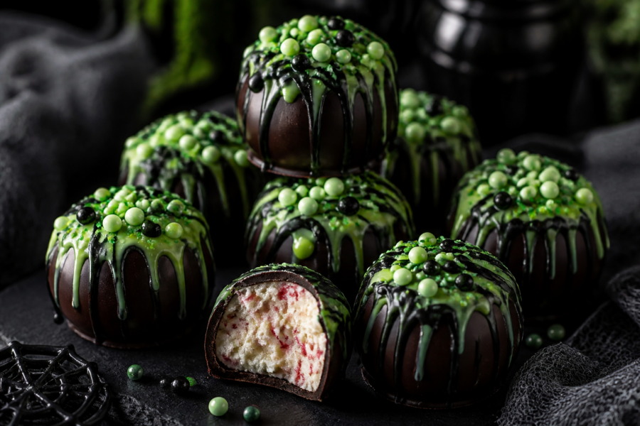 No-bake Halloween peppermint cauldron truffles with dark chocolate dip and green-black witch brew drizzle