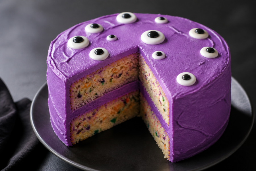 Purple buttercream Halloween monster eye cake with vanilla sprinkles and candy eyes