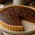 Salted caramel espresso chocolate tart with glossy ganache on crisp shortbread crust