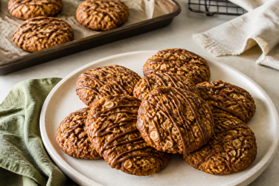 Finished soft pumpkin oatmeal cookies with espresso glaze, craggy tops and visible oats
