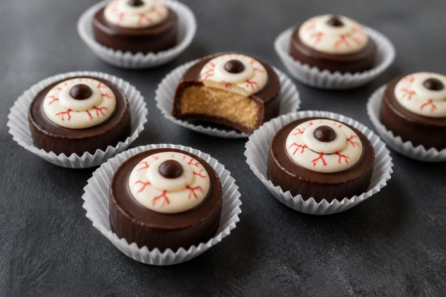 Halloween eyeball peanut butter cups in mini paper liners with dark chocolate and white eyeballs