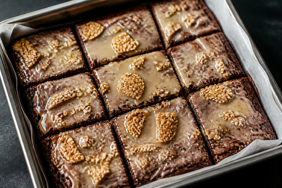 Salted maple miso fudge brownies with toasted sesame brittle, sliced into squares