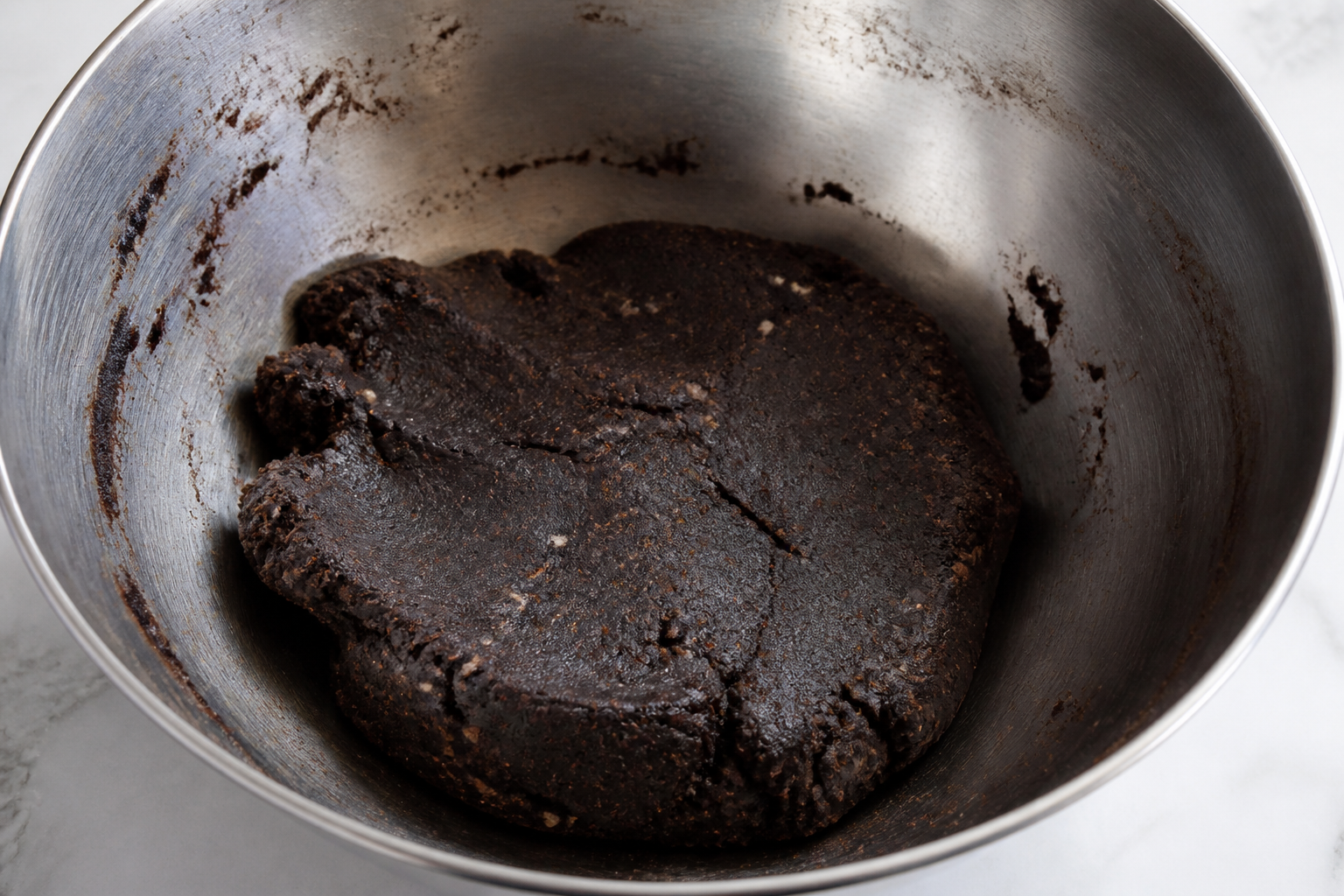 Black cocoa almond linzer dough mixed and formed into a chilled disk