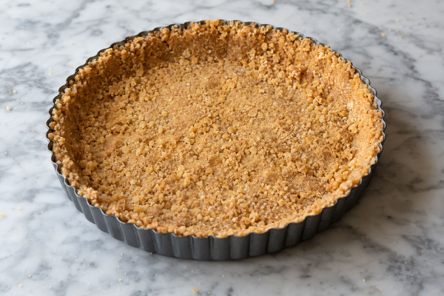 Pressed vanilla wafer crust mixture in a tart pan