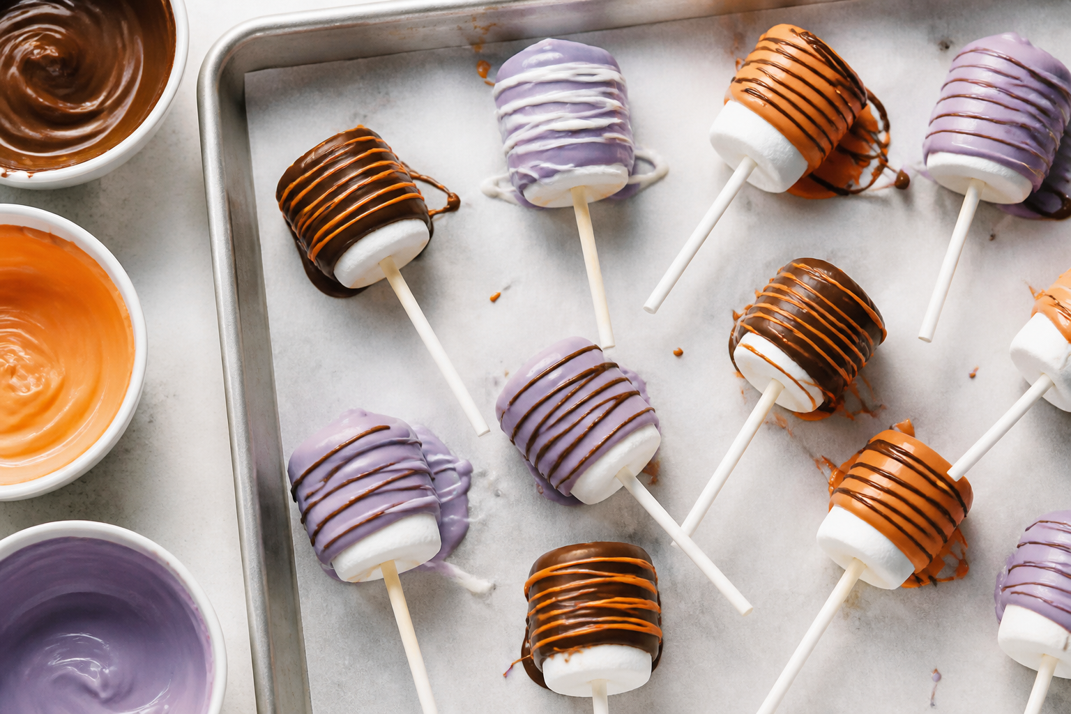 Top-down view of cooling tray of dipped Halloween marshmallow pops
