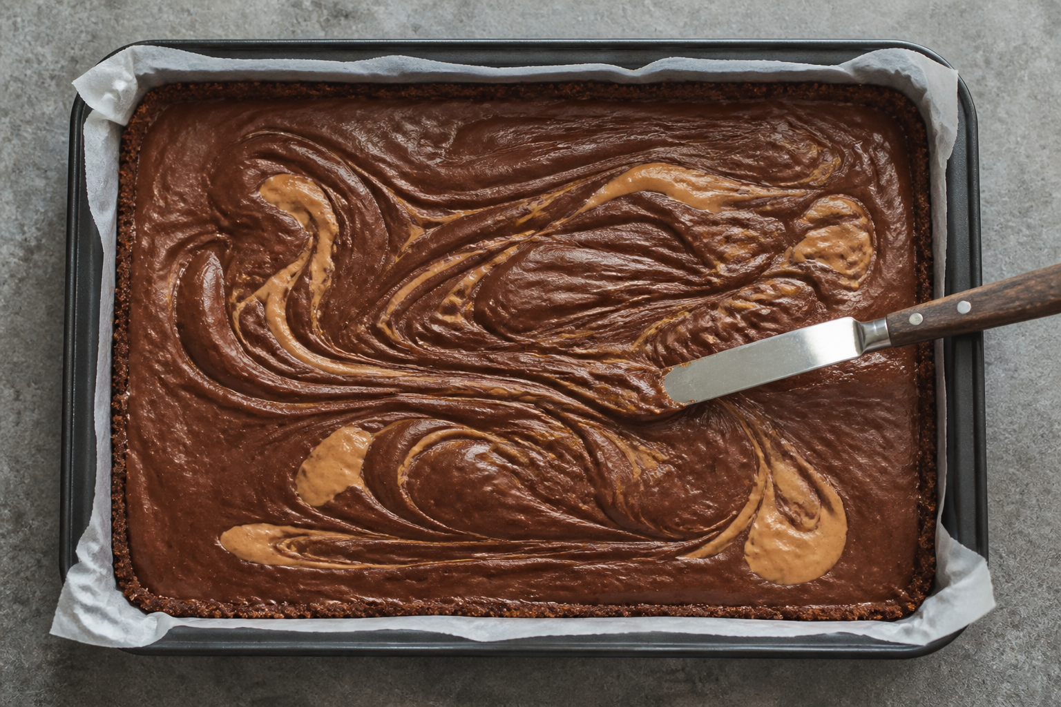 Top-down view of the pan with visible chocolate swirl process