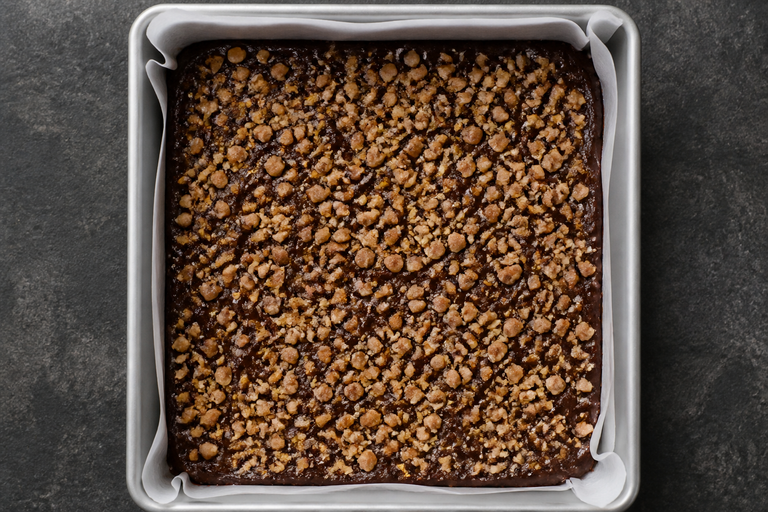 Assembled stage: 8x8 pan with brownie batter topped with toasted walnut crumble