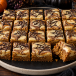 Halloween pumpkin cheesecake blondies with cinnamon swirl