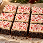 Peppermint bark brownies with white chocolate topping and crushed candy canes on a Christmas dessert platter.