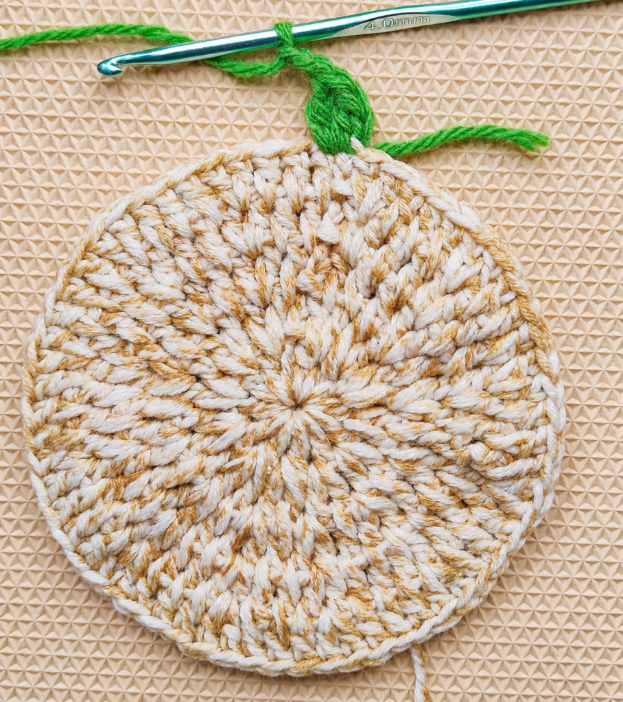 Completed first green V-stitch with two stitches skipped before the next cluster.