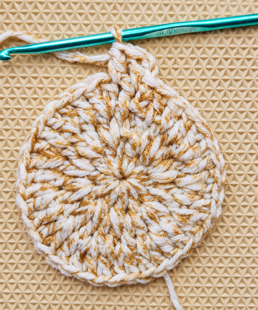 Round 4 beginning with two individual double crochets before an increase.