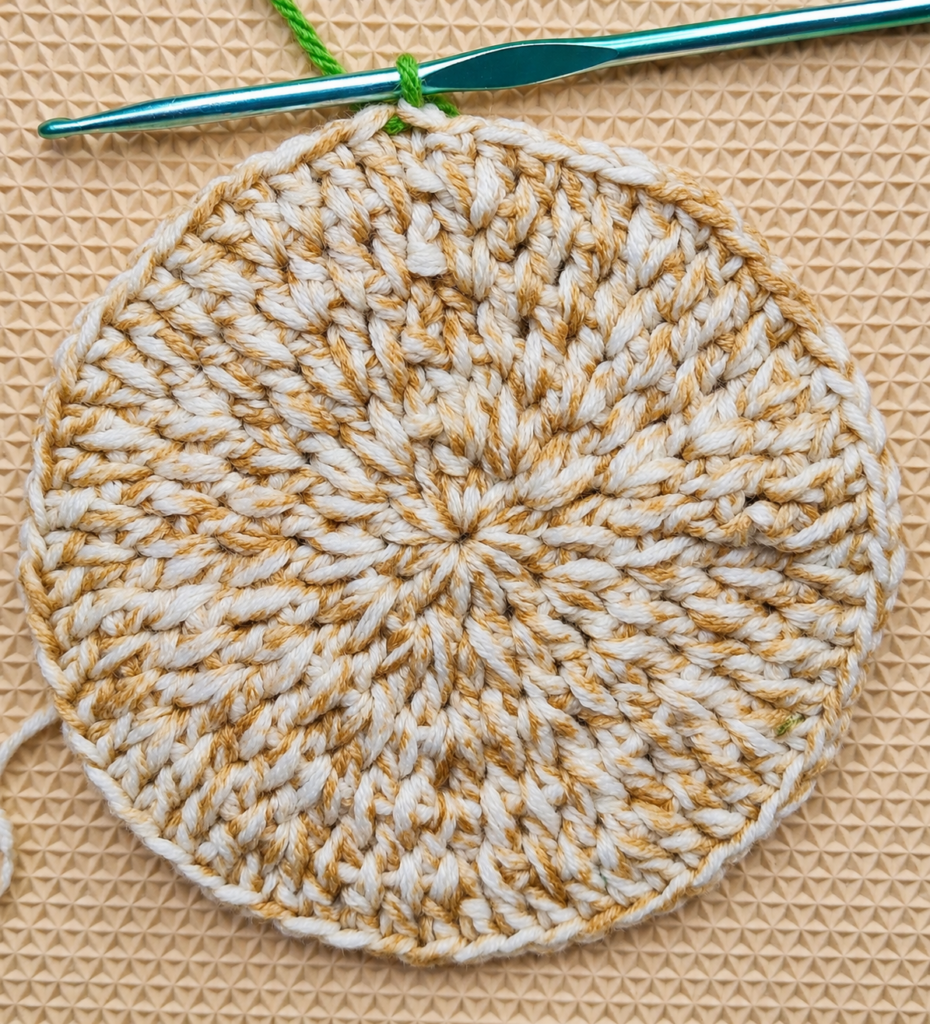 Green yarn pulled through the joining stitch at the end of Round 5.